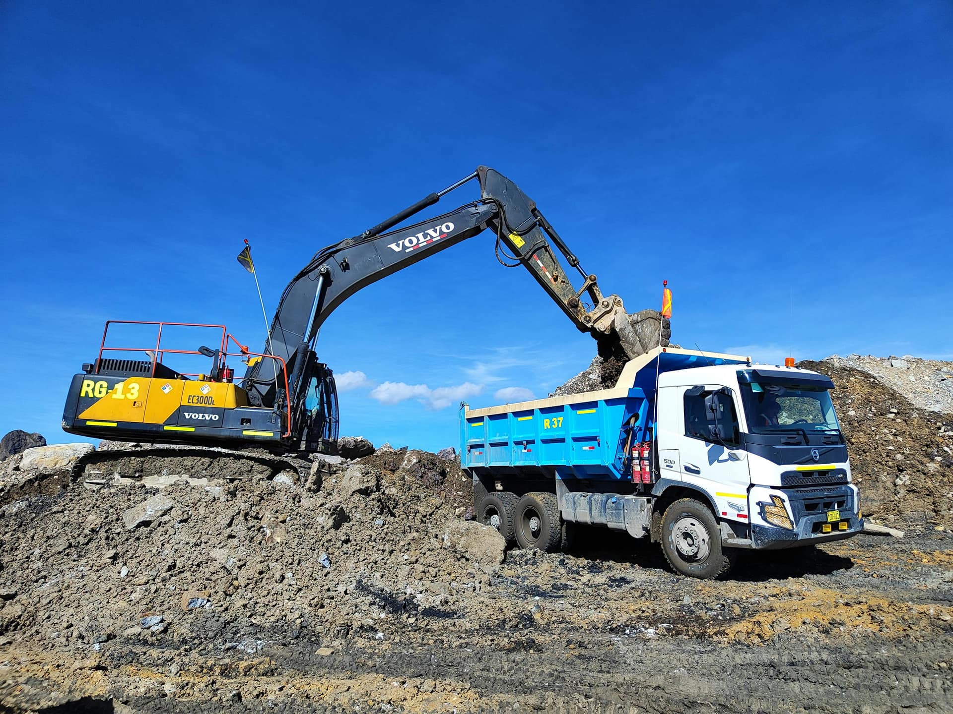 Excavator loading a haul truck in an open-pit mine